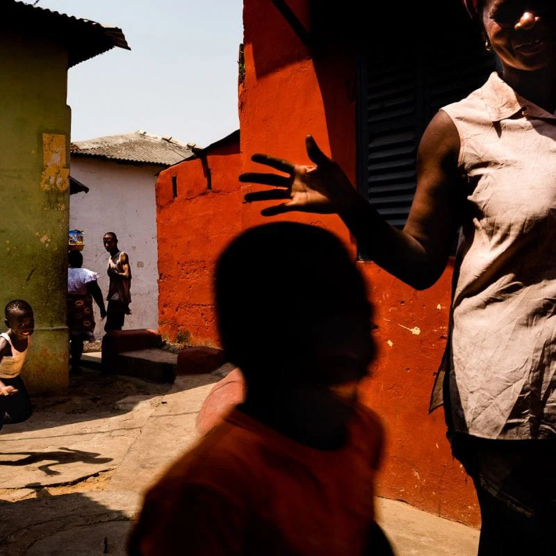street photography, colorful images with high contrast and shadows in Ghana, Africa, by ivan Margot