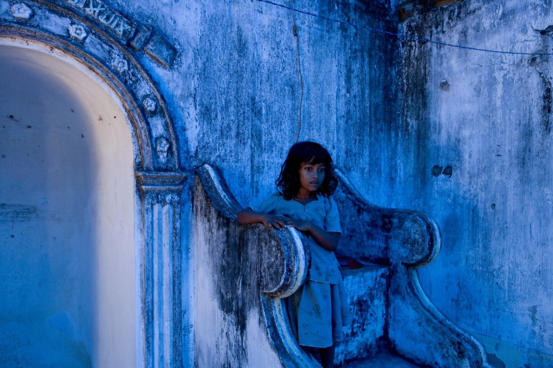 Muslim girl takes up shelter at a destroyed mosque after fleeing a government offensive against the Tamil Tigers in Sri Lanka by Ron Haviv from the VII photo agency