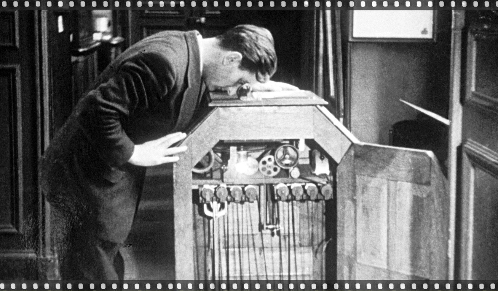 A man watching a moving picture through the Edison kinetoscope, 1889