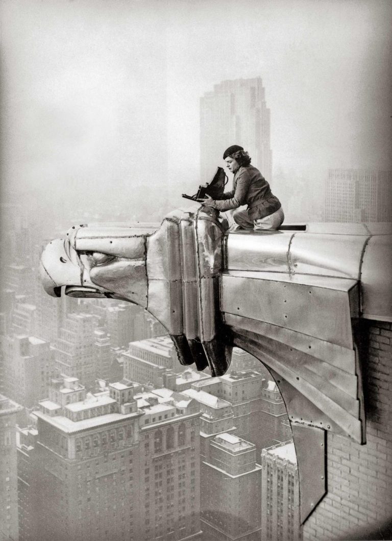 Margaret Bourke-White perches on an eagle head gargoyle, New York, 1935 © Oscar Graubner Legendary Women in Photography