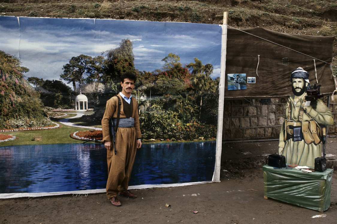 A proud Peshmerga soldier pays to have his photograph taken on the streets of Arbil. Northern Iraq, 1991