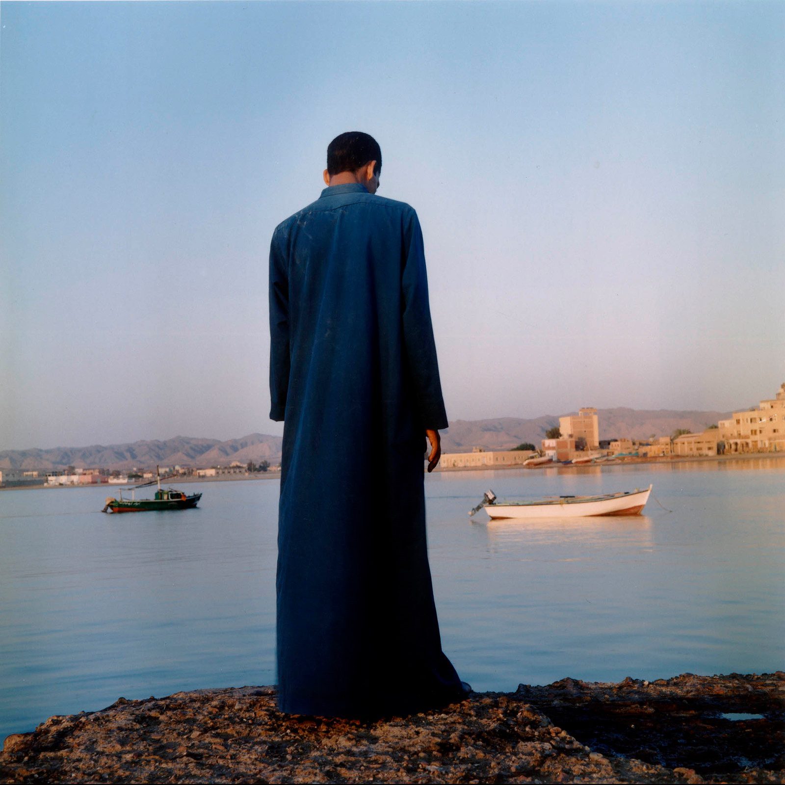 Man looking at the Red Sea, El Qusier, 2003 photograph by Denis Dailleux