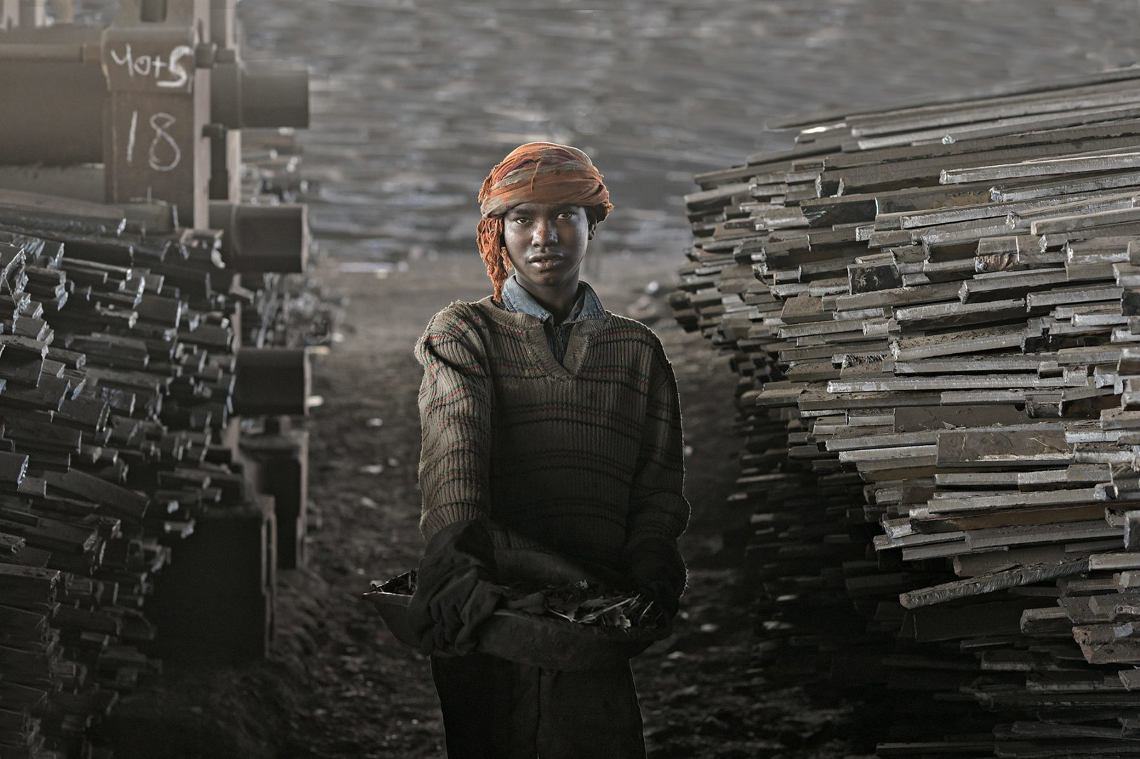 Color portrait photograph of a boy working in a shipyard in Dhaka, Bangladesh - Visual Storytelling Award