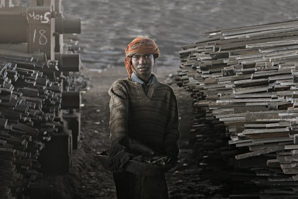 Color portrait photograph of a boy working in a shipyard in Dhaka, Bangladesh - Visual Storytelling Award