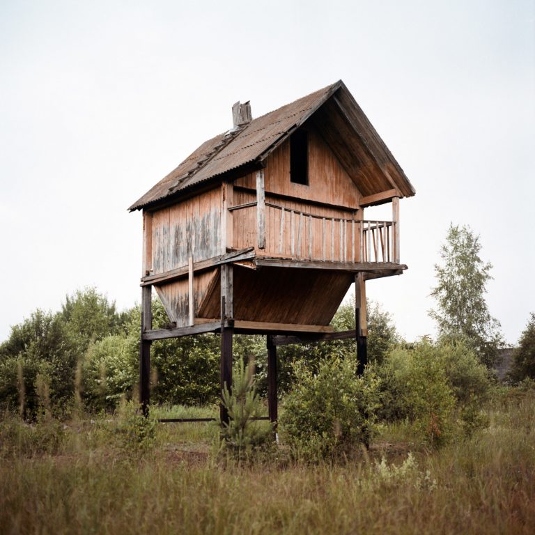 Color photograph by Tadas Kazakevičius, from Soon to be Gone abandoned building, field, trees