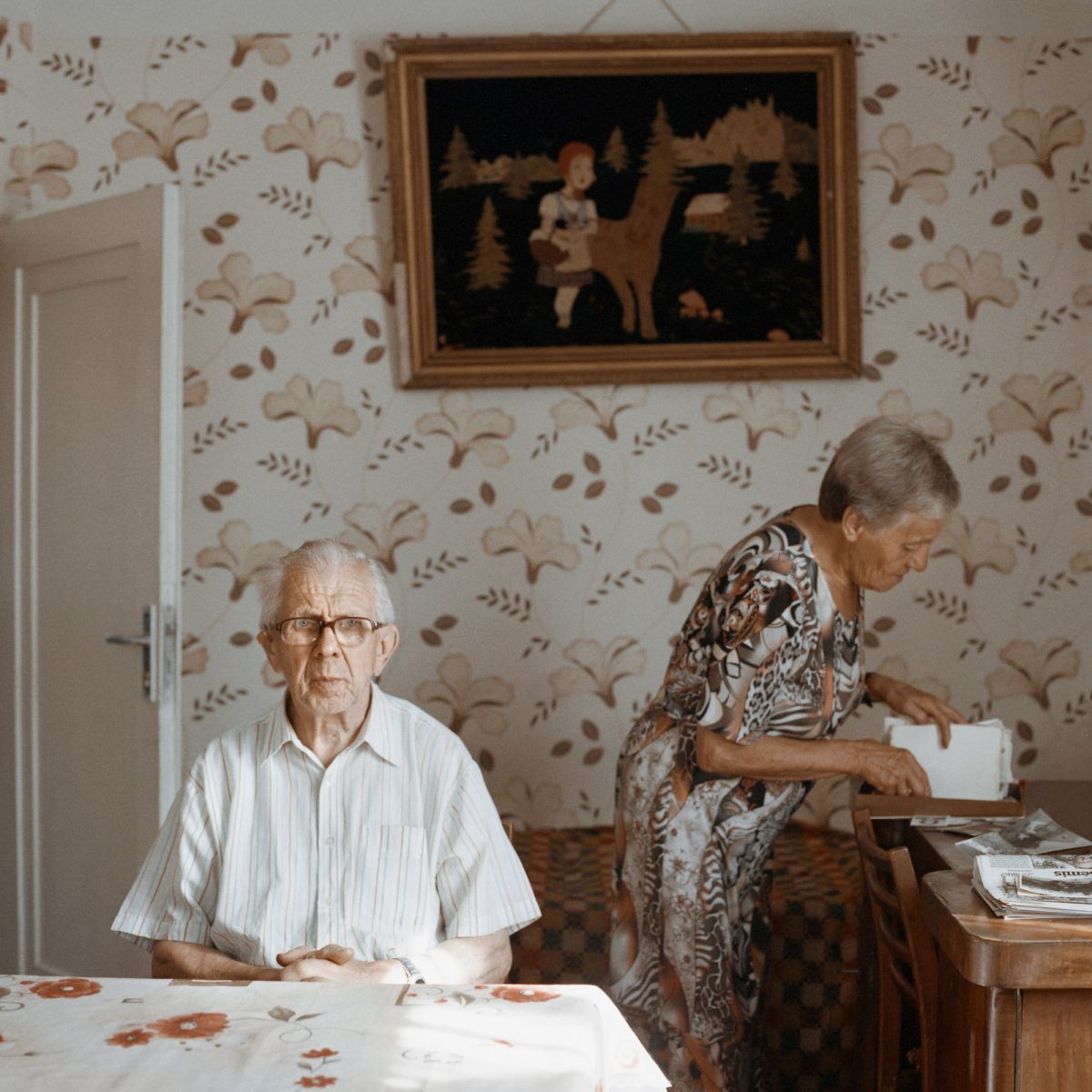 Color photograph by Tadas Kazakevičius, from Soon to be Gone portrait, elderly man and woman at home, wallpaper