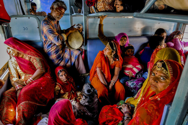 color photo of people traveling in train in Rajasthan, India by Robi Chakraborty
