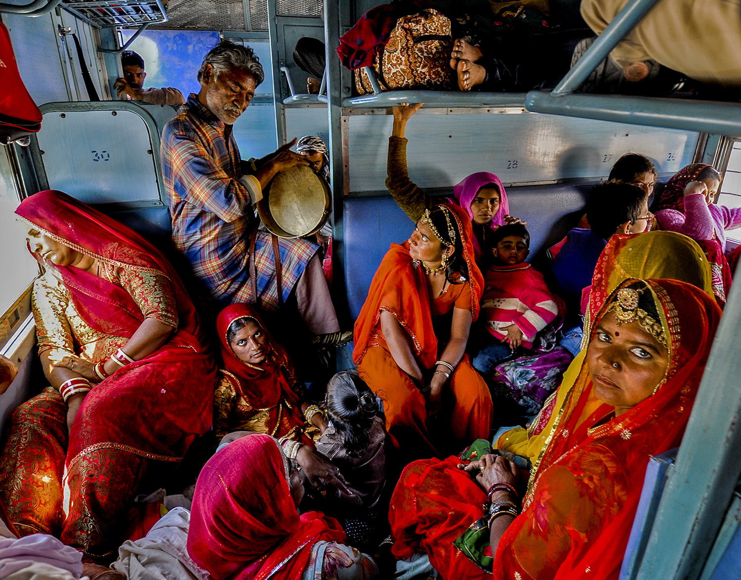 color photo of people traveling in train in Rajasthan, India by Robi Chakraborty