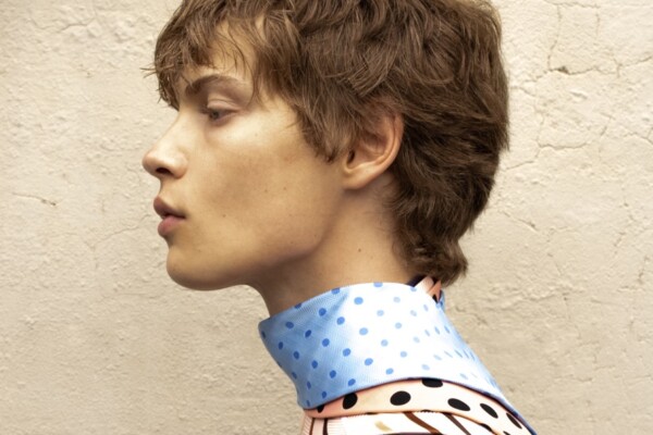 color fashion studio portrait of a male model wearing ties by Blake Sutherland