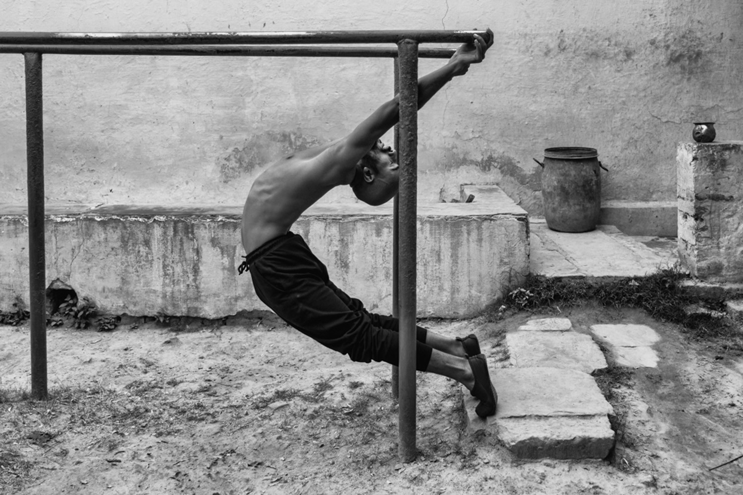 black and white street photo man gym varanasi india