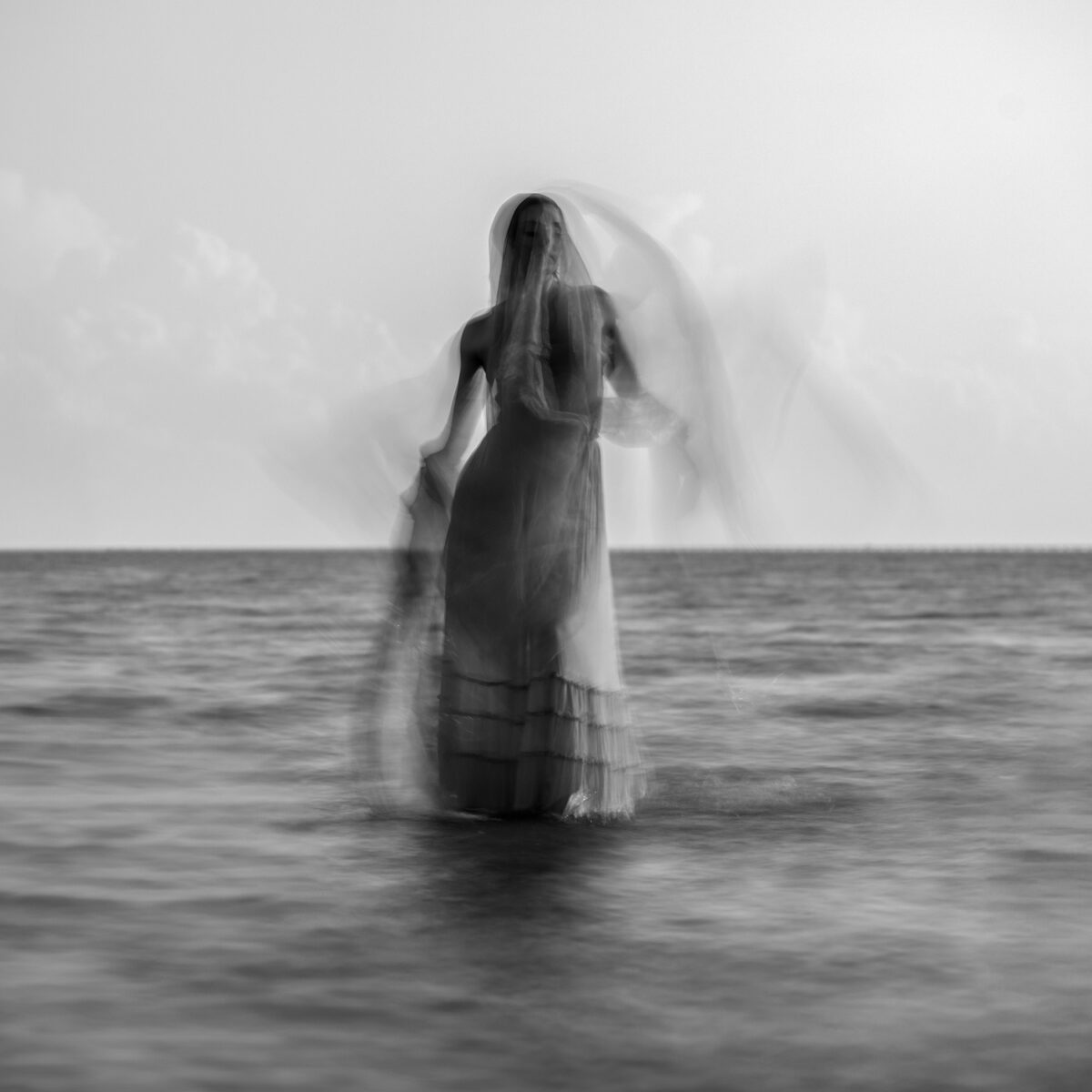 Black and White abstract medium format film portrait of woman in water by Dusty Cooper