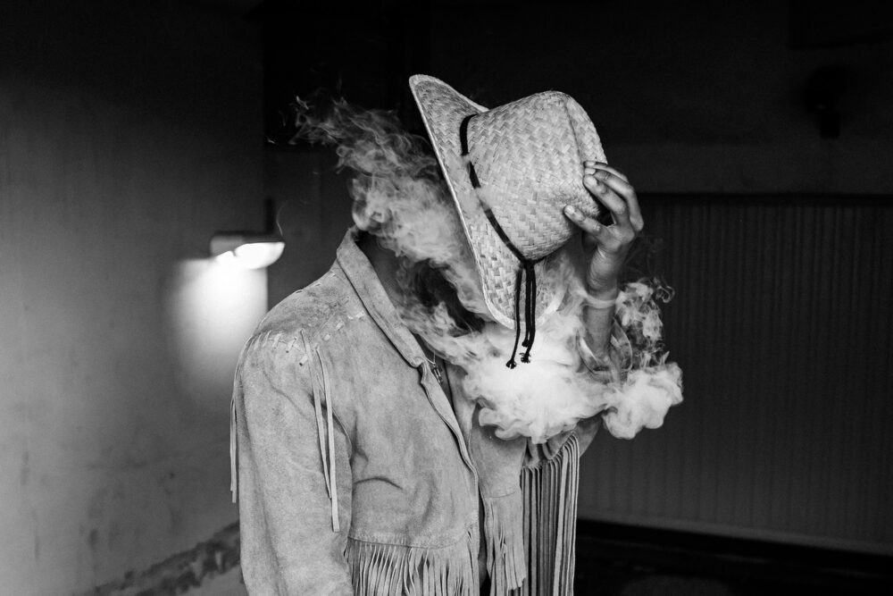 black and white photo of man and cloud cigarette smoking by Lauriane Bieber