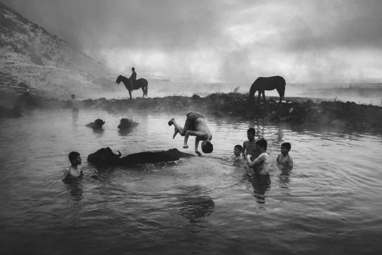 black and white photo of boys and animals swimming in Bitlis, Turkey by Yusuf Eminoglu. - Best images 2025