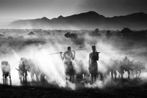 black and white photo of herders in Omo River, Ethiopia by Roberto Gennaro