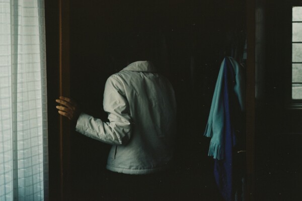 Photography by Ana Hop. An elderly woman in shadows of a room