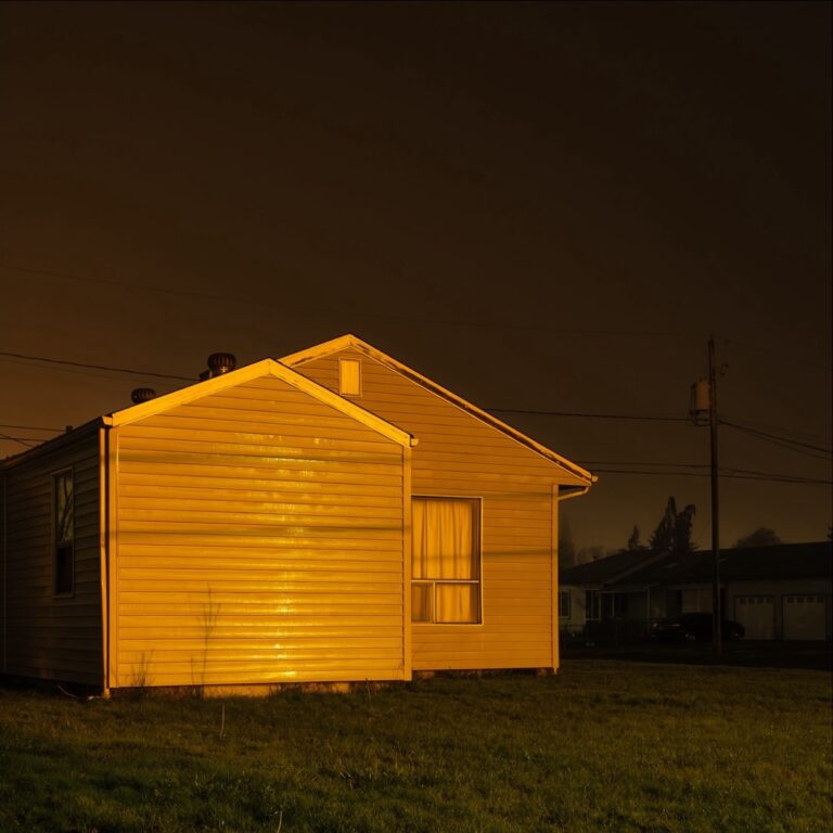 Color landscape photography by Bill Holderfield. House at night illuminated with yellow light. USA