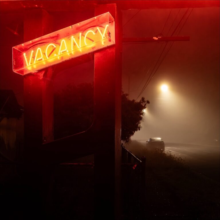 Color landscape photography by Bill Holderfield. Red vacancy neon sign next to a road