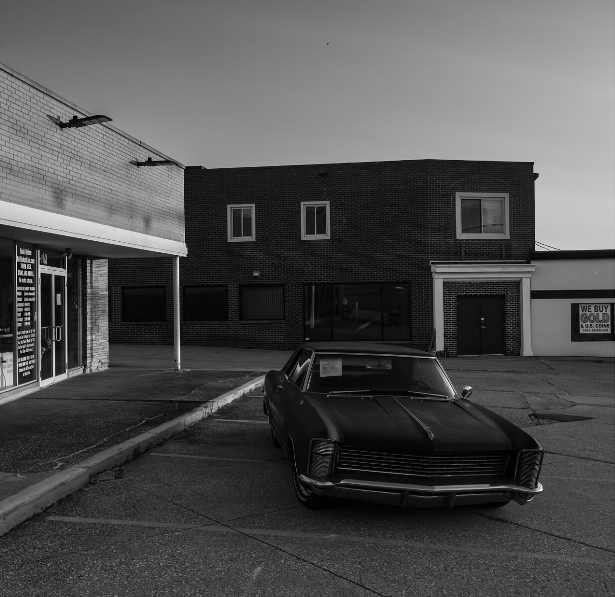 Black & white landscape photography by Bill Holderfield. Car in front of store