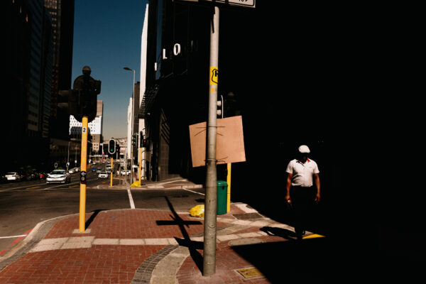 color photography of man walking in the street in South Africa by Ivan Knyazev
