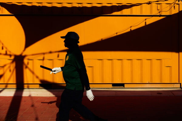 color street photography of man shadow with white gloves in Coney Island, NYC, USA, 2024 by Jean-Marc Bara