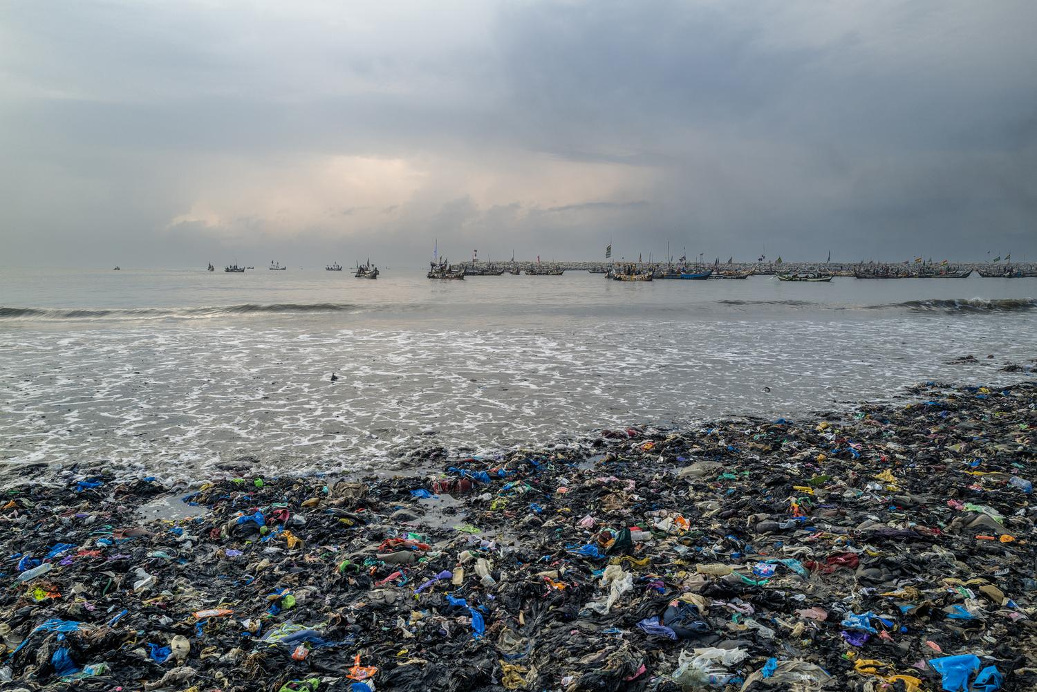 Photography by Kasia Trojak. Clothing waste on the beach in Accra, Ghana