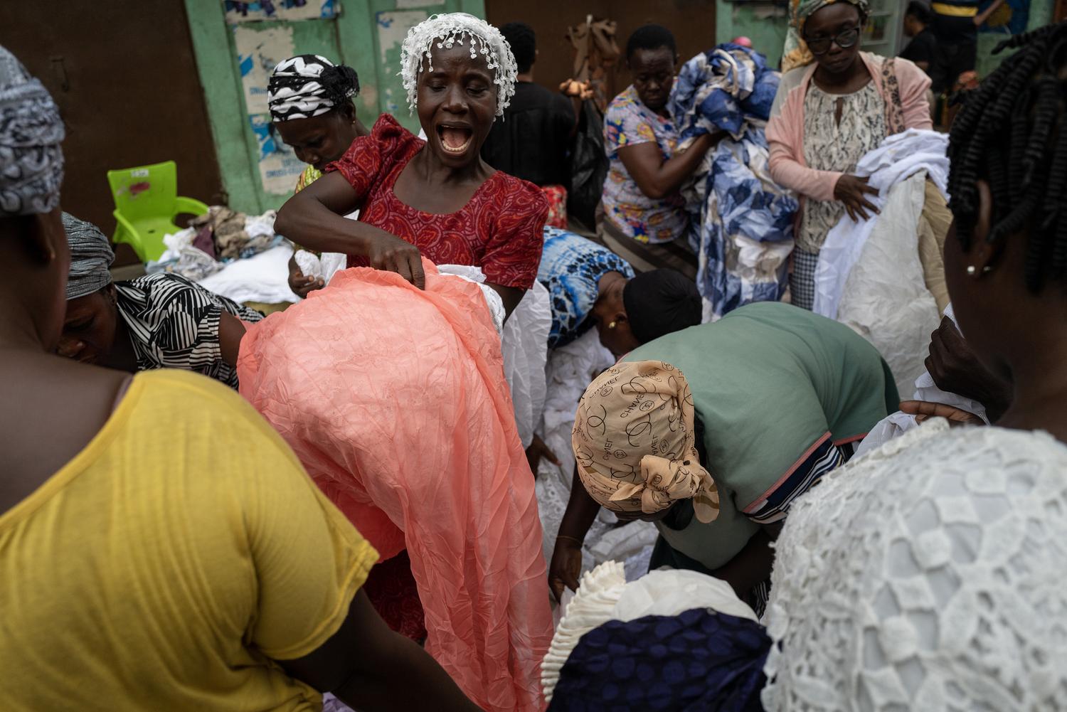Photography by Kasia Trojak. Women buying fabric in Accra, Ghana.