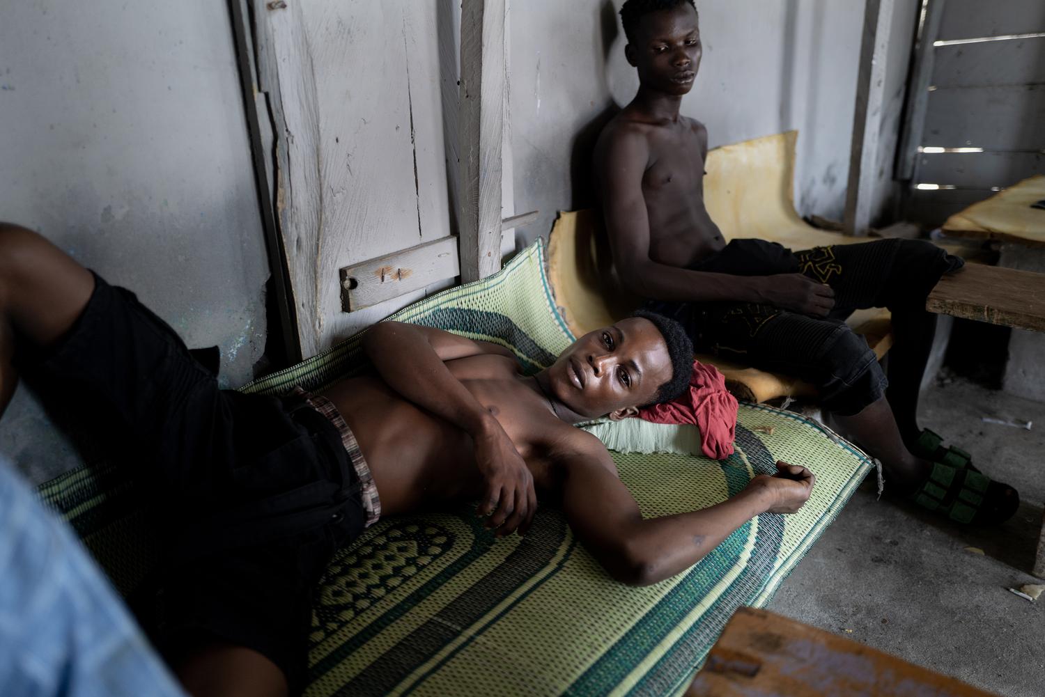 Portrait photography by Kasia Trojak. Two young men relaxing in a house in Accra, Ghana.
