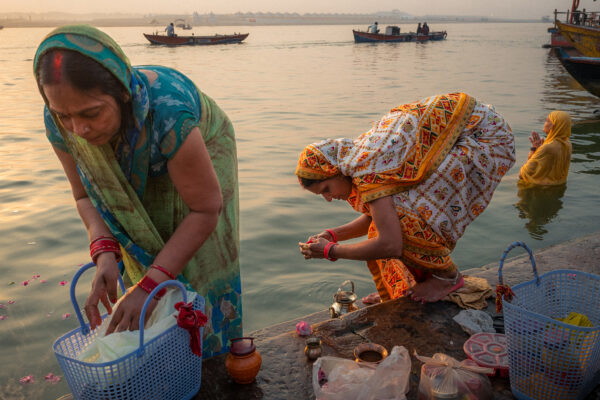color street photography of women washing in Ganges in Varanasi, India by Will Fortune