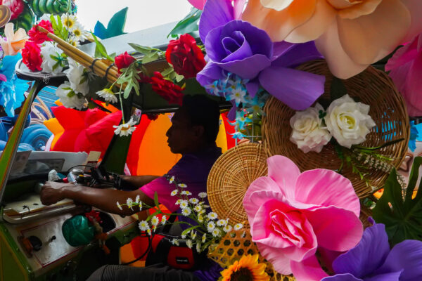 color photo of a tuk-tuk driver in Bangkok, Thailand by Phatsakorn Bundasak