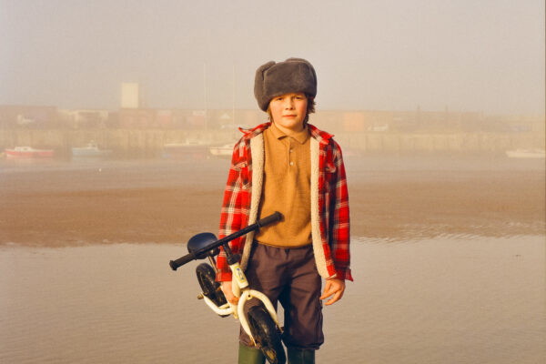 Color portrait photo of young boy by the sea in Margate beach, England, by Ben Hickling