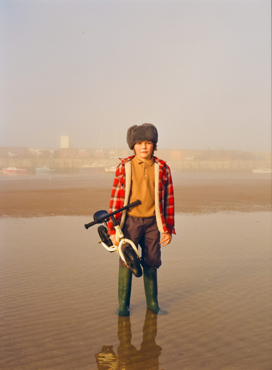 Color portrait photo of young boy by the sea in Margate beach, England, by Ben Hickling