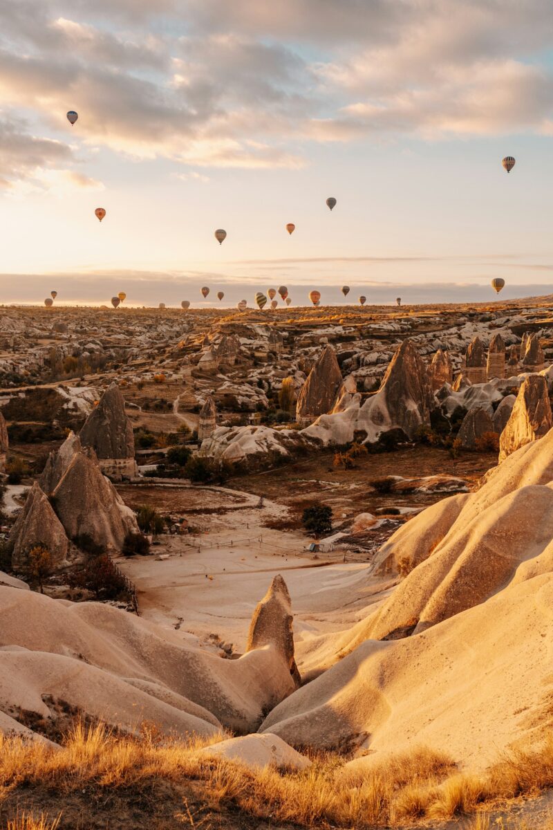 Sunrise over rocky landscapes and hot air balloons, Capadoccia, Turkey by Igor Sporynin