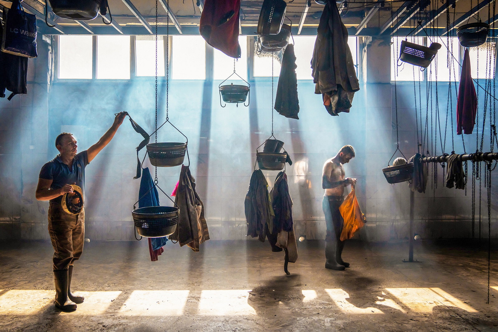 Two men changing after work in a factory in Turkey by F. Dilek Yurdakul