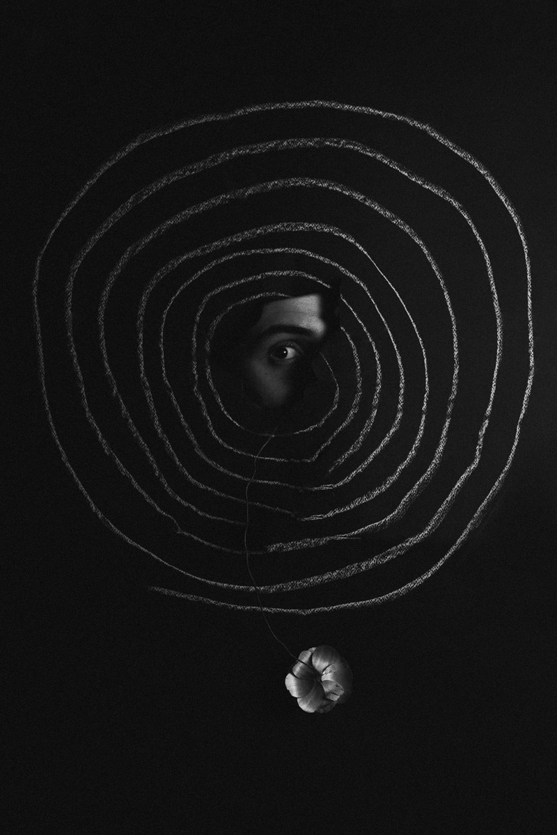 Black and white abstract photo collage of an eye and crayon circles by Alex Othwnos