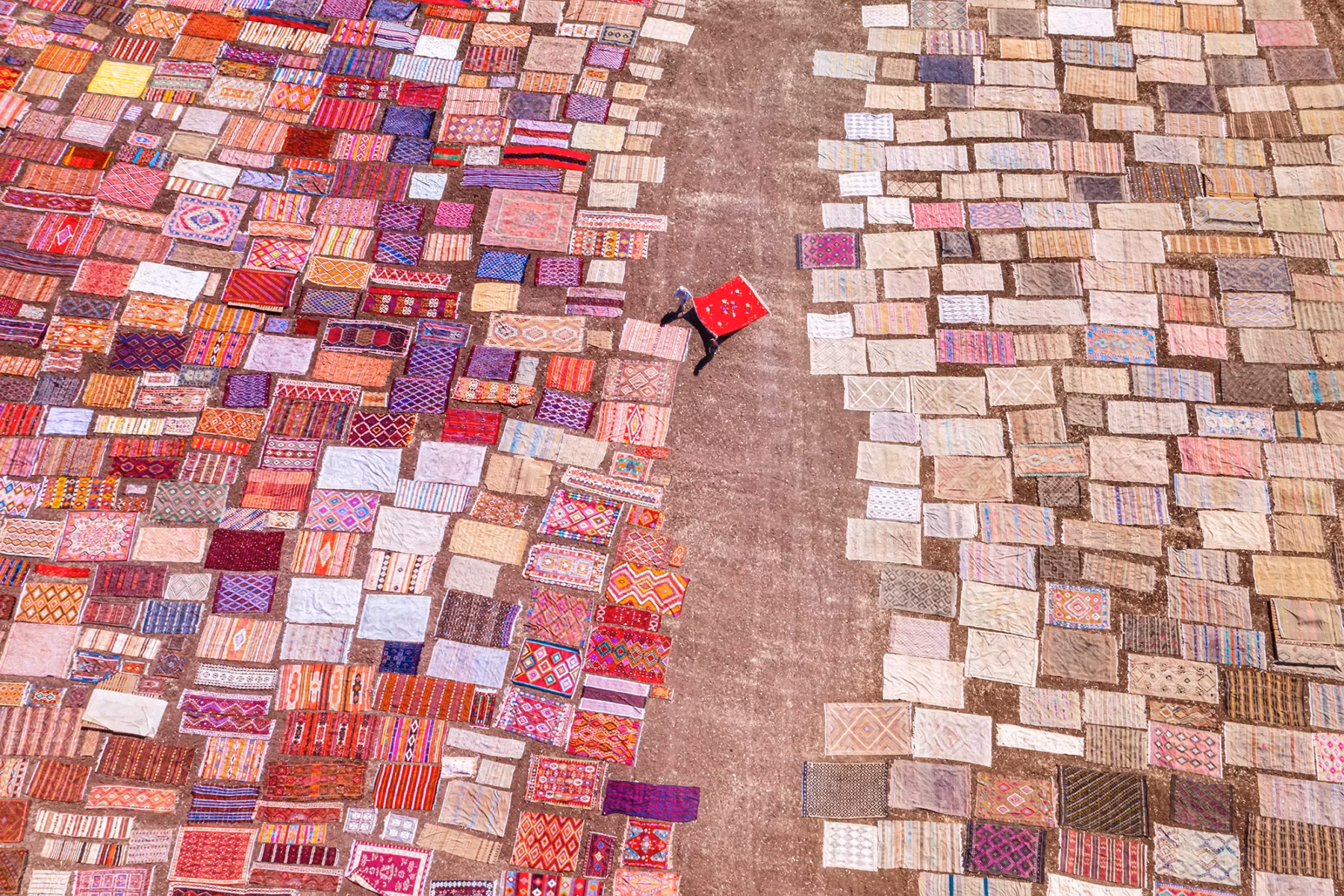 Aerial photo of a woman and colorful carpets in Antalya, Turkey by F. Dilek Yurdakul