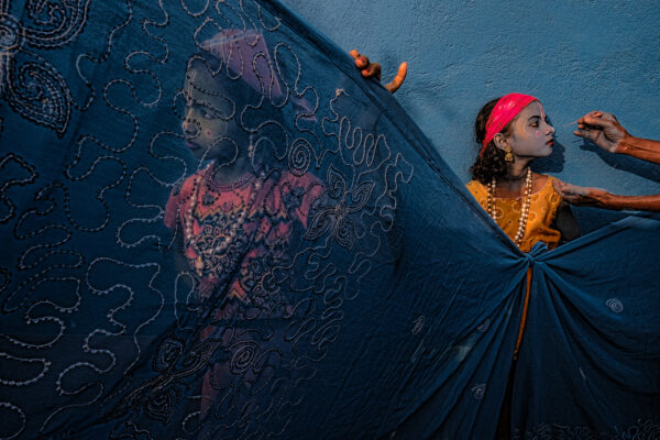 color travel portrait photo of two girls getting a face paint for traditional celebration in west Bengal, India, by Somenath Mukhopadhyay