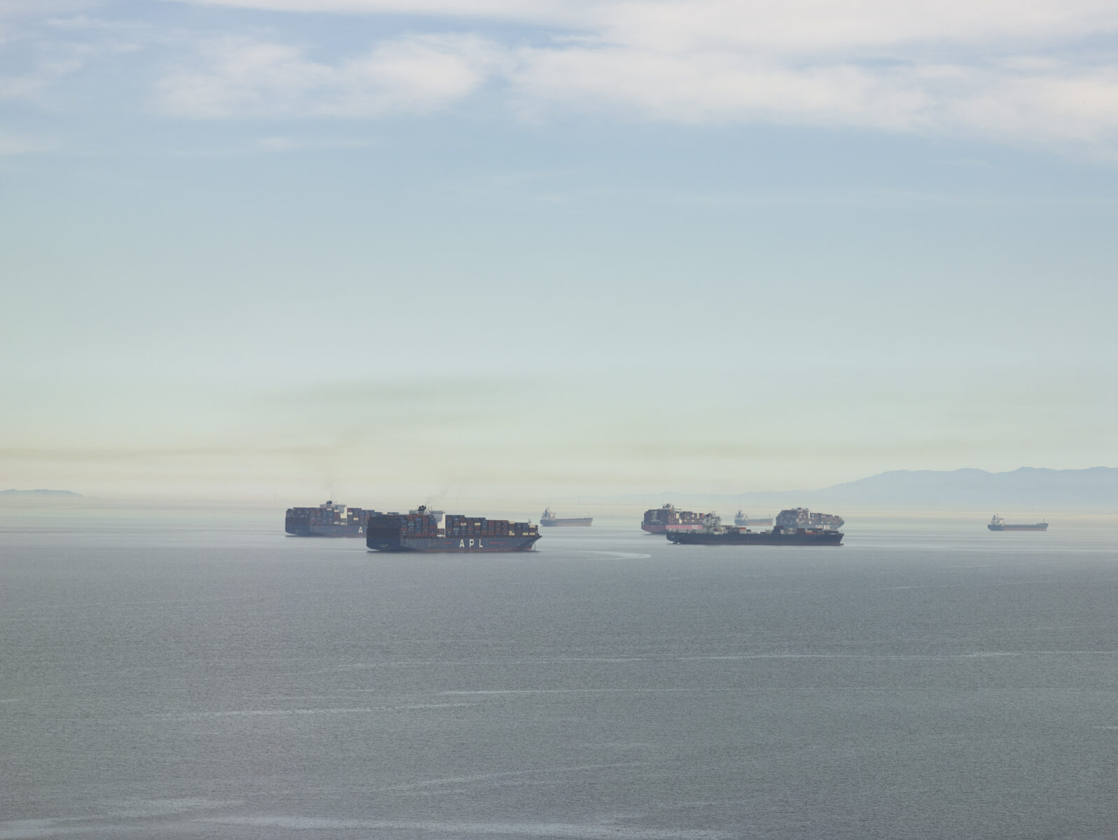 Landscape photography by Richard Misrach. Ships under a blue sky, late dawn, San Francisco Bay.