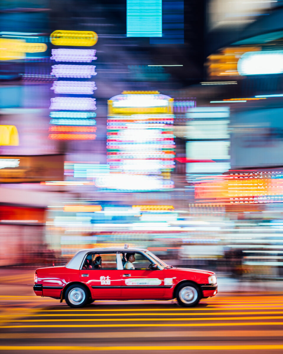 color photo of hong Kong taxi at night by Christiaan Hart