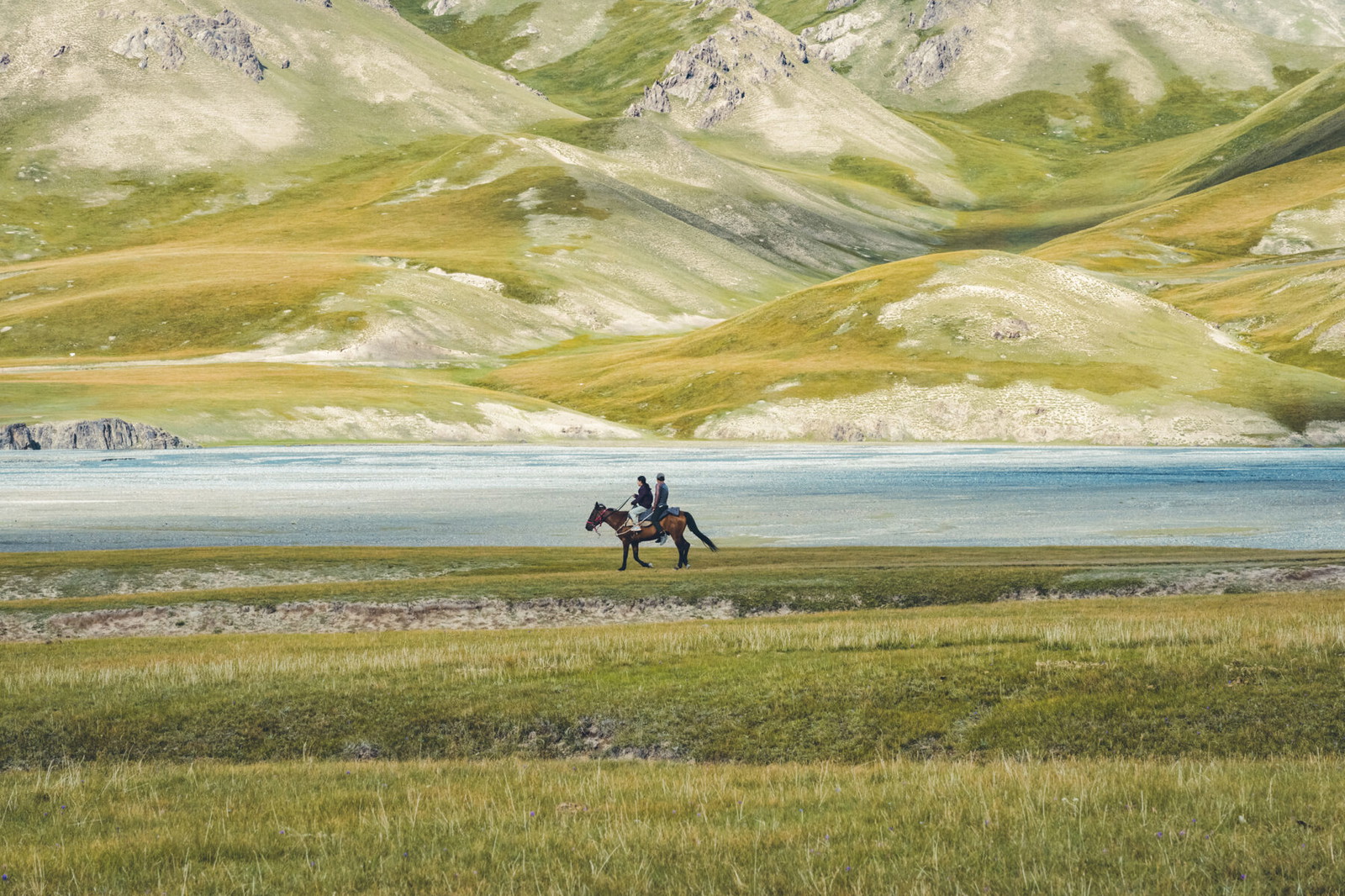 color travel photo of two young nomad riders in Kyrgyzstan by Émilie Favier