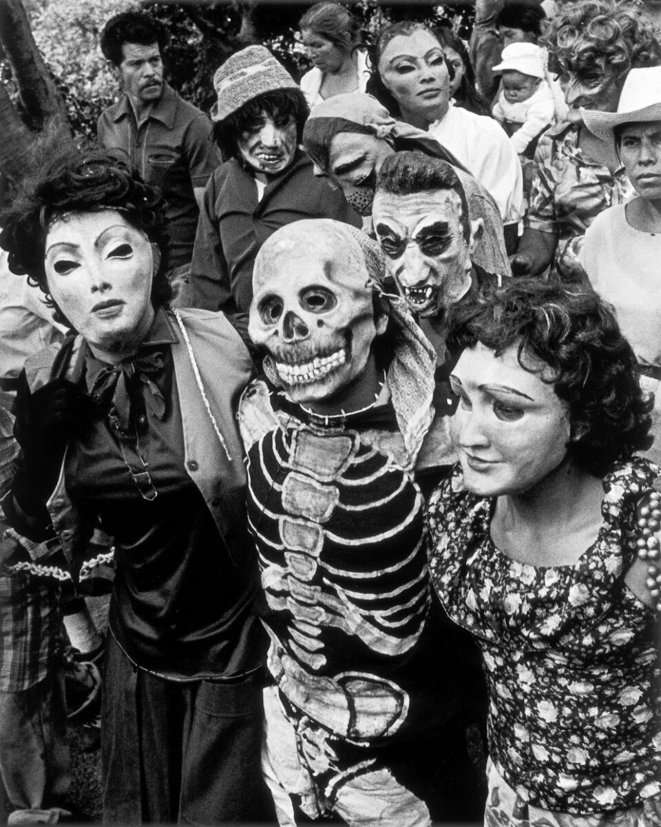 Black & white photography by Graciela Iturbide. A group of people in masks, Mexico