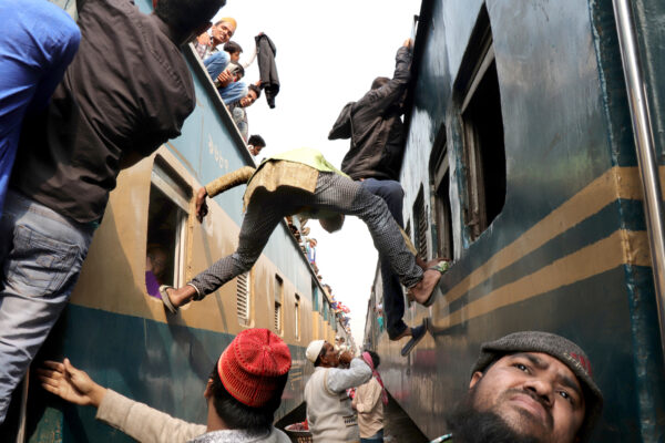 candis street shot of people boarding trains in Dhaka, Bangladesh by Deba Prasad Roy