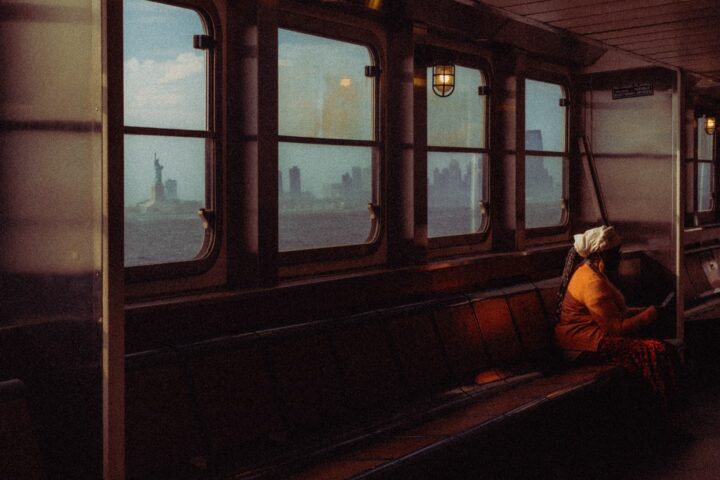 Color street photo of woman in boat in New Yor by Eren Sarigul