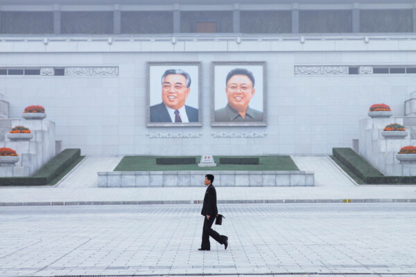 color photo of man walking in Pyongyang, North Korea by Luke Gram