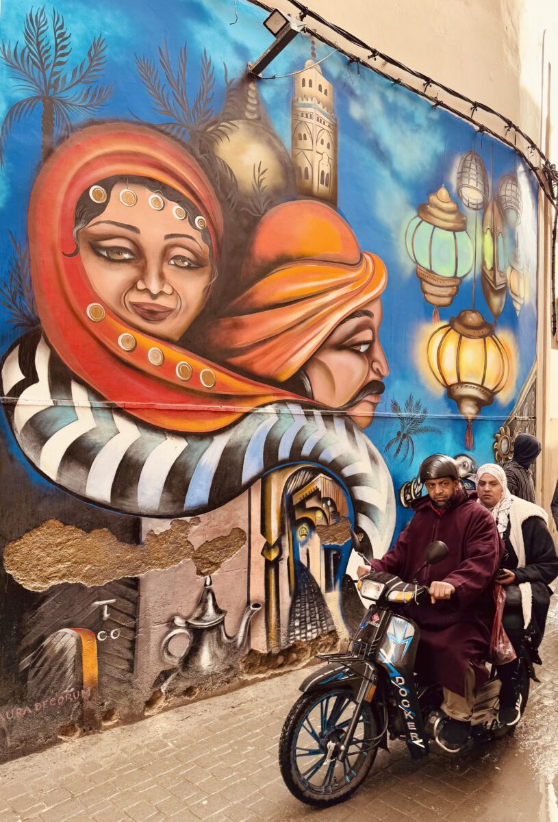 color street photo of man and woman on scooter in Marrakech by Paddy Butler