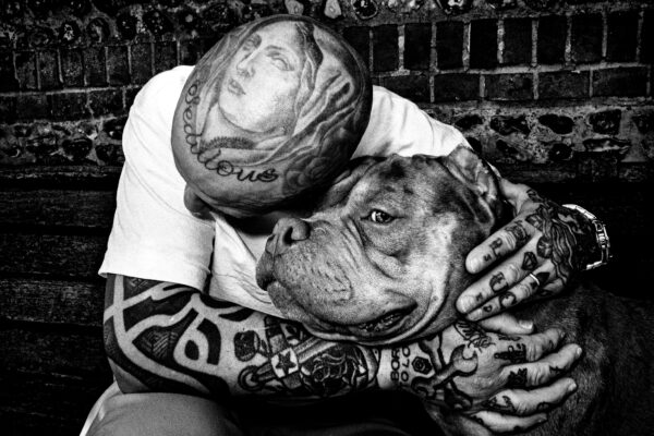 black and white street photography portrait of tattooed man and dog in Brighton, England, by Paul Spencer