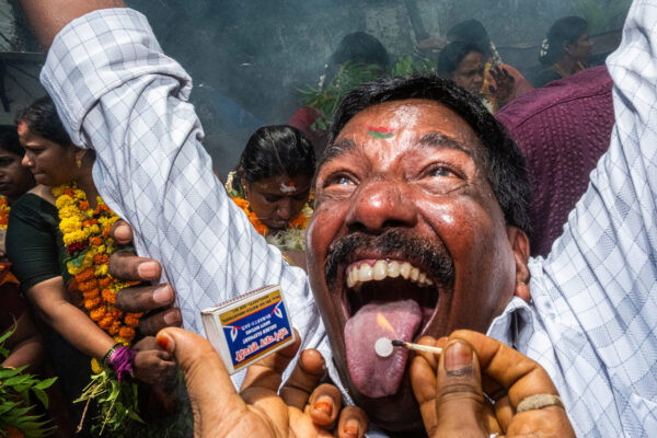color street photo of man at a ceremony in Mumbai, India by Suresh Naganathan
