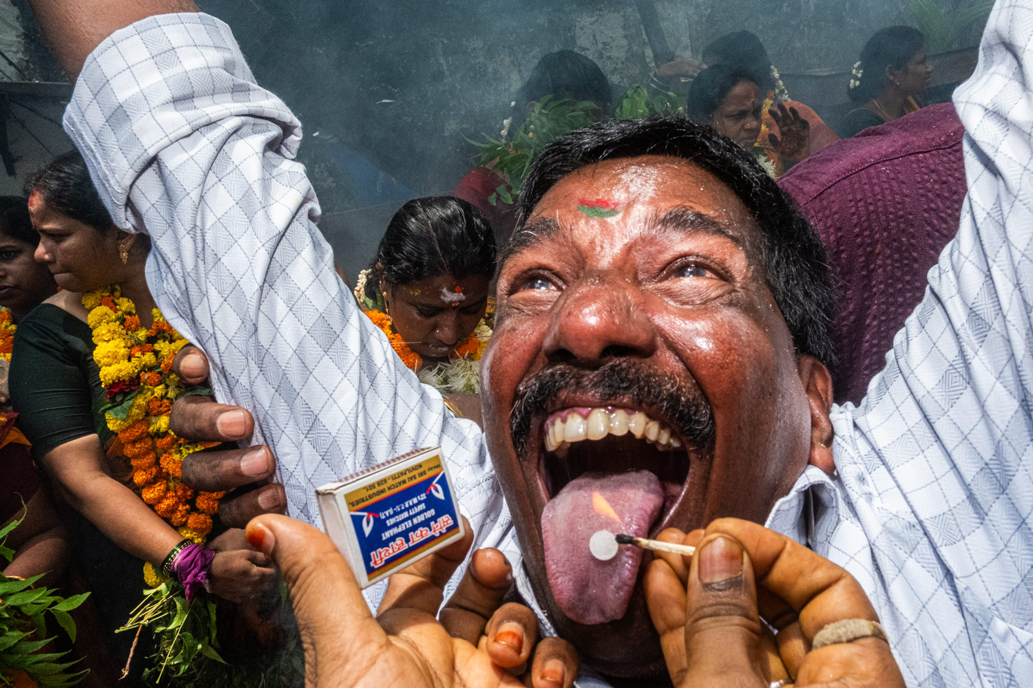 color street photo of man at a ceremony in Mumbai, India by Suresh Naganathan