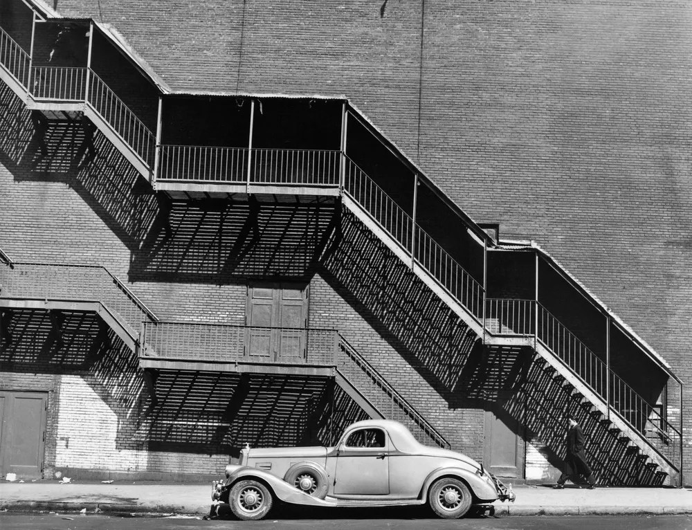 Black and white photography by Todd Webb. A car and stairway, NYC, 1946