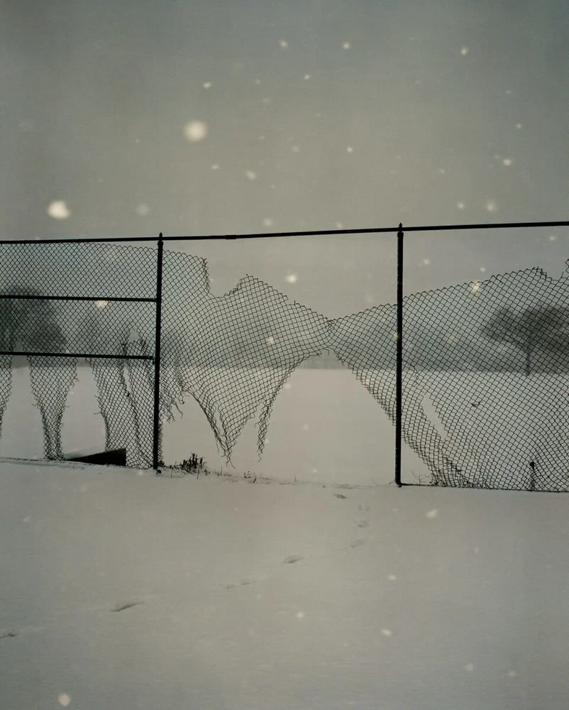 Documentary photography by Gregory Halpern. Broken fence surrounded by snow covered fields