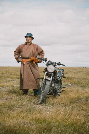 color portrait photo of a man and motorcycle in Mongolia by Dylan Canderle